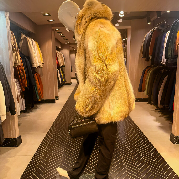 Elegant display of premium men's leather jackets in a luxury Istanbul showroom. Model wearing a high-end leather biker jacket and a stylish biker vest.  Close-up of a luxury leather fur jacket men and a fur and leather vest. Sophisticated men's trench coat and coat men designs for the 2026 season. Artisan crafting a bespoke men leather jacket at the Mahal Hasan workshop.
